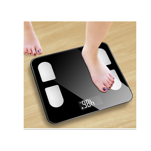 Body fat scale with app displaying weight, foot on scale, modern design, black tempered glass surface.