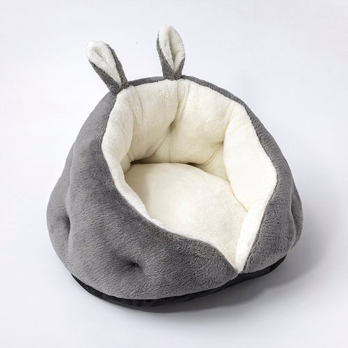 Gray pet bed with white interior on a light gray background